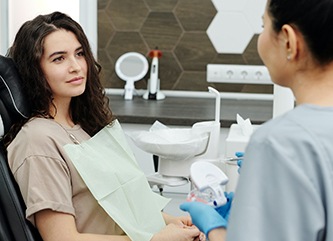 Female patient speaking with dentist