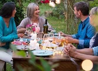 Woman with dental crown in Dix Hills at dinner party