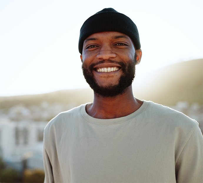 Man with beard and grey shirt smiling