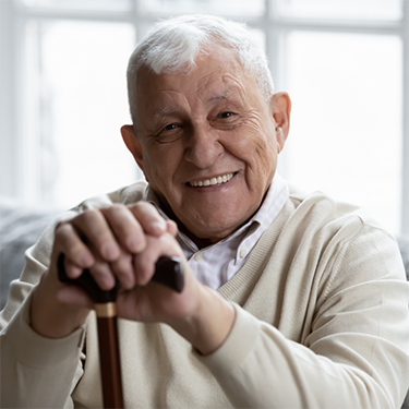 Smiling older man with a cane