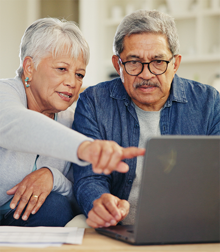 Older man and woman looking at laptop together