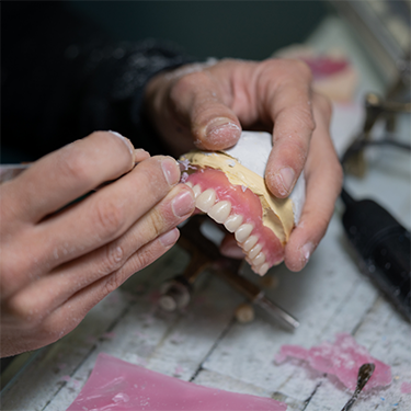 Lab technician working on dentures