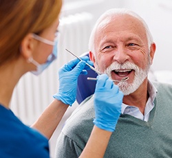 Man smiles at dentist