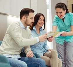 A dentist talking to her patients about insurance options.