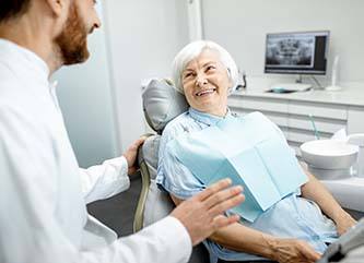 Woman smiling at her Dix Hills implant dentist