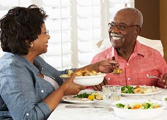 Couple with dental implants in Dix Hills enjoying a meal together