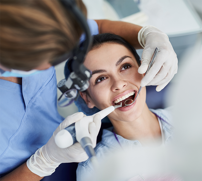 Female patient having dental exam performed
