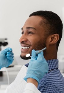a patient smiling during a dental checkup near Huntington