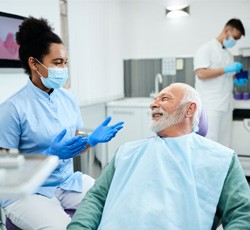 : Man smiling in a dental chair