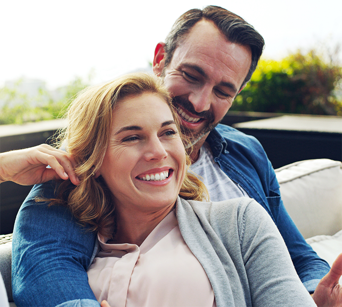 Woman sitting in man's lap on a couch