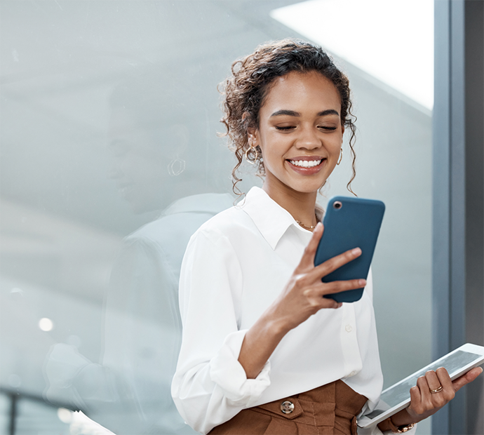 Woman in white shirt checking her cell phone