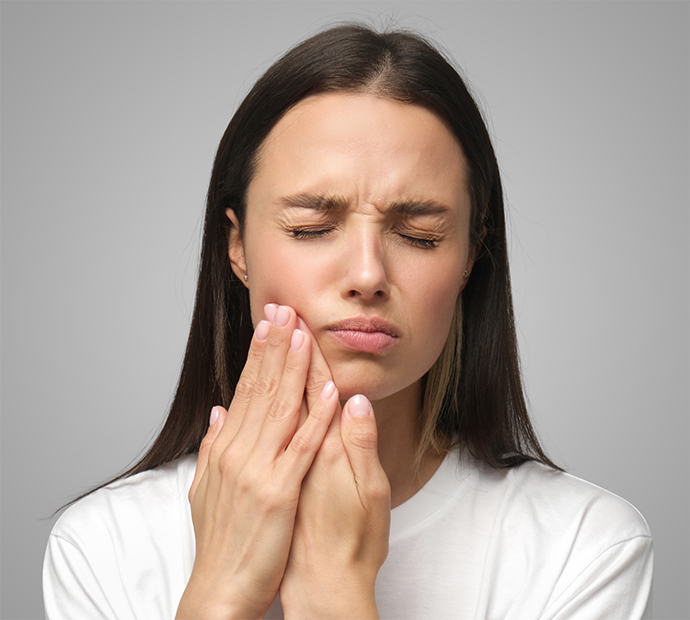 Woman in white shirt with tooth pain