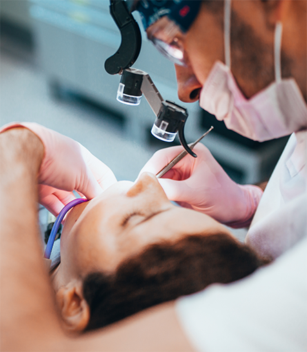 Close up of patient being treated by dentist with mask