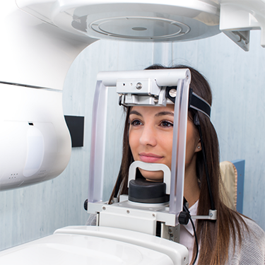 Female patient about to have dental X-rays taken