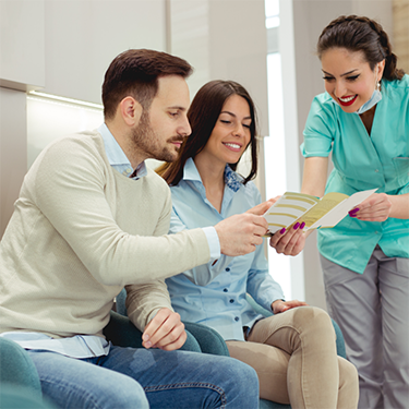 Showing brochure to male and female patient