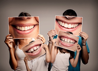 Family holding images of their smiles.