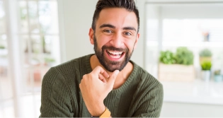 Bearded man in green shirt smiling