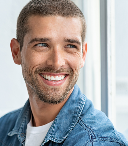 Smiling man in denim jacket