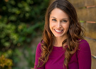 young woman smiling after getting veneers in Dix Hills