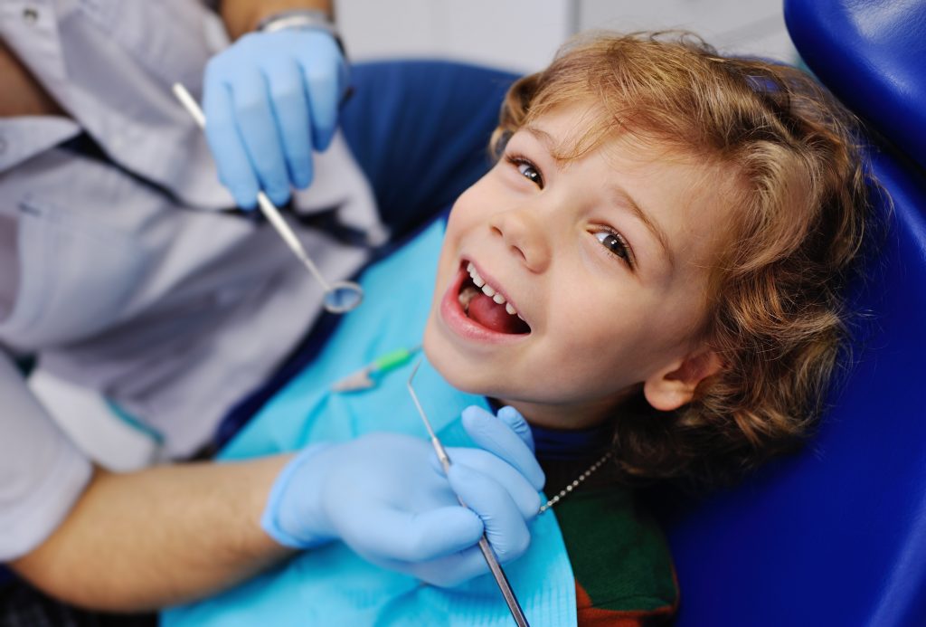 A smiling little boy in the dental chair