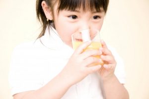 little girl drinking juice