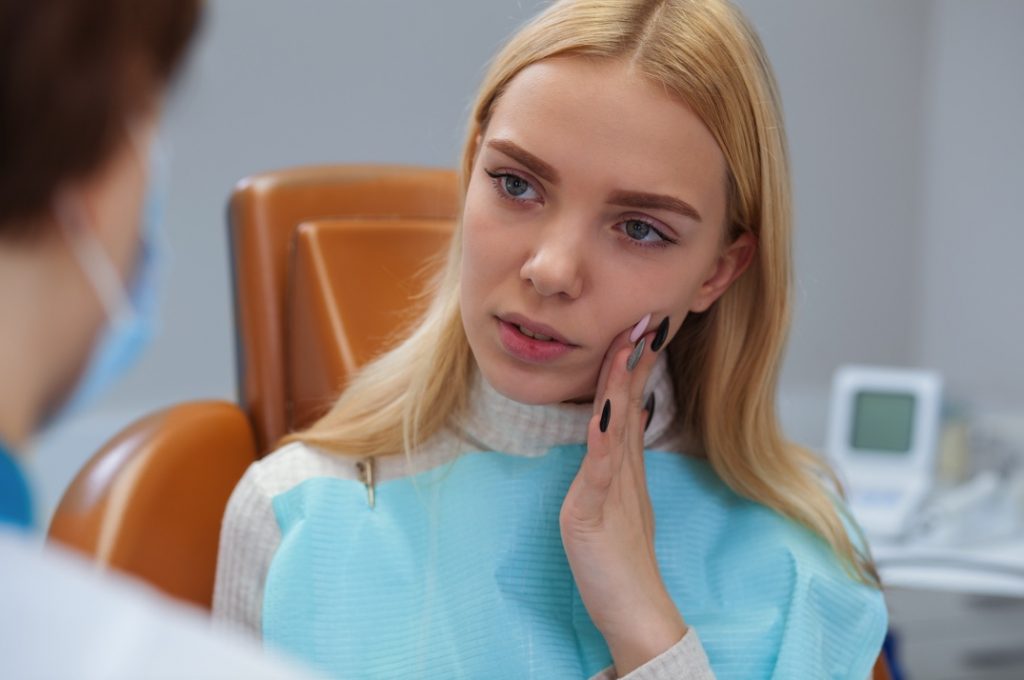 Woman at emergency dentist in Dix Hills