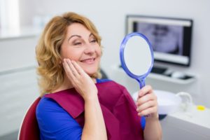 older woman happy with dental implants in Dix Hills