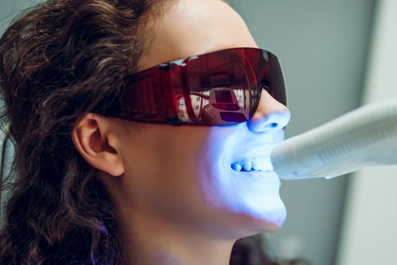 person with gray teeth undergoing whitening treatment