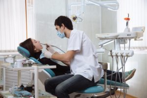 Dentist caring for woman in dental chair