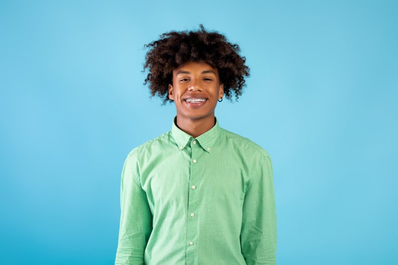 A teenager smiling after his pediatric dentistry appointment