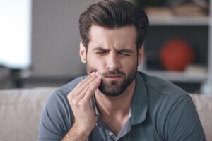 Man experiencing tooth sensitivity